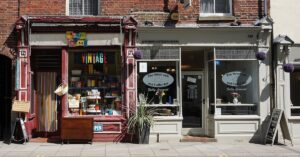 Vintage shop and cafe in Norwich showcasing eclectic storefronts and vibrant signage.