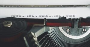 Classic typewriter with text 'rewrite... edit...' on paper.