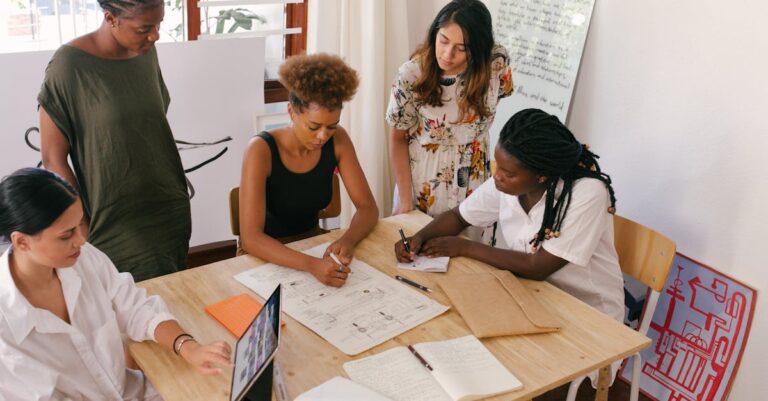 Diverse team collaborates on a project using digital and paper resources in a bright office.