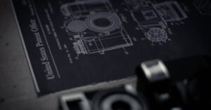 Detailed blueprint of a camera with an official patent from the United States Patent Office.