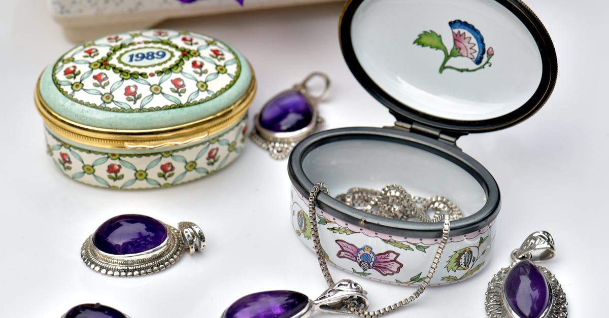 Stunning porcelain jewelry boxes with amethyst pendants and intricate designs, perfect for luxury collections.