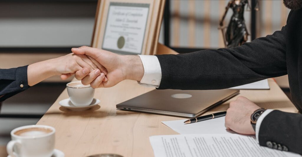 A formal handshake over a business contract in a corporate office setting.